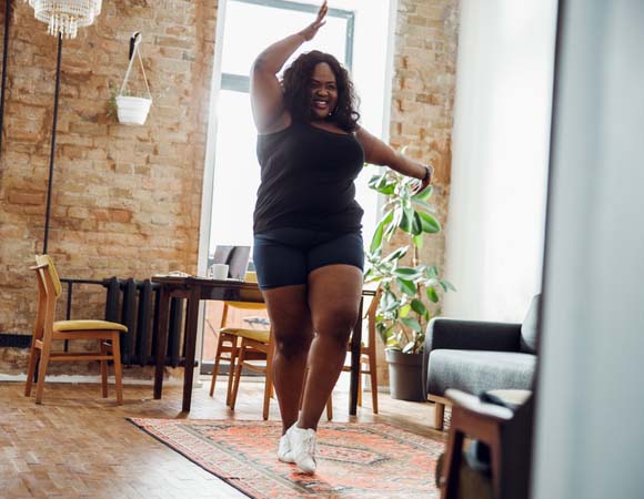 Black woman smiling while doing aerobic exercise